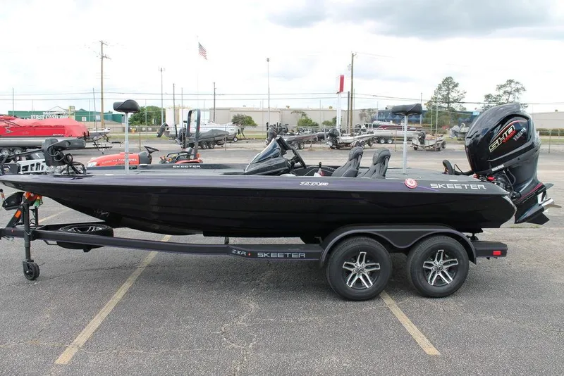 Slide: The Image of 2025 Skeeter ZXR19 boat on trailer, parked in a lot, side view. - 5