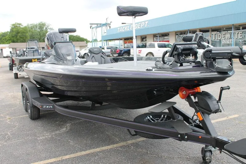 Slide: The Image of 2025 Skeeter ZXR19 boat on trailer in parking lot near tackle shop. - 7