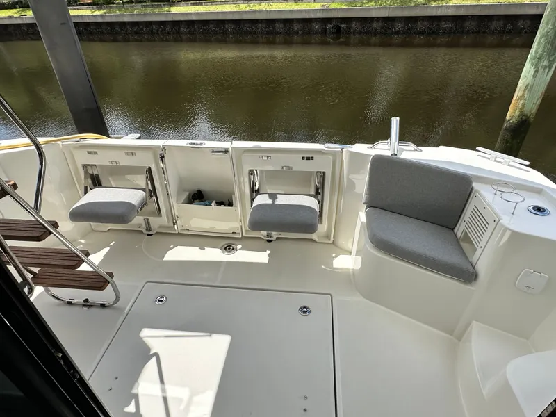 Slide: The Image of 2022 Beneteau Swift Trawler 35 cockpit with seating and water view. - 13