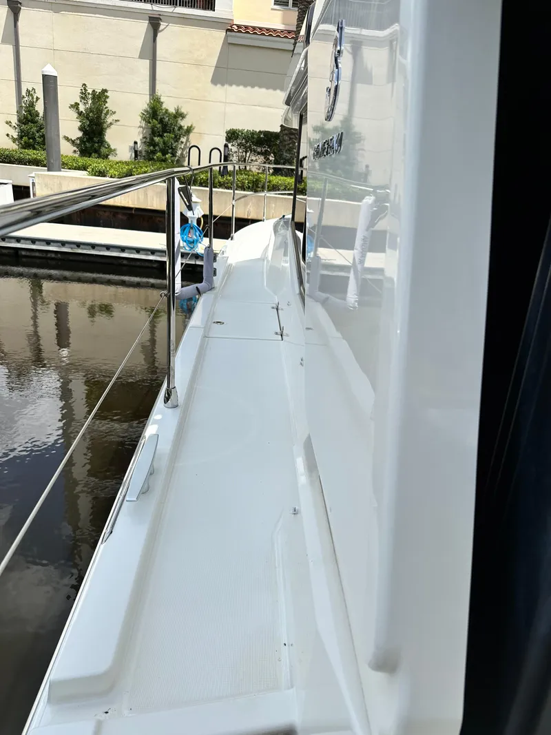 Slide: The Image of 2022 Beneteau Swift Trawler 35 side deck view at marina. - 17