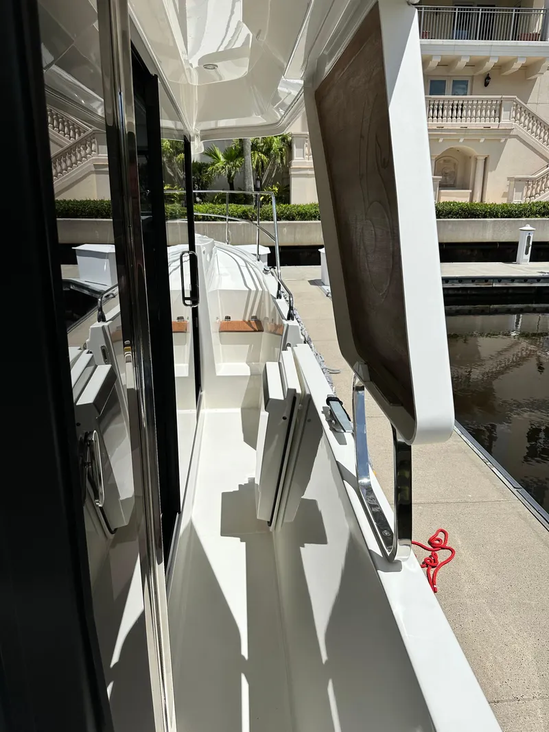 Slide: The Image of 2022 Beneteau Swift Trawler 35 docked, showcasing sleek side deck and modern design. - 18