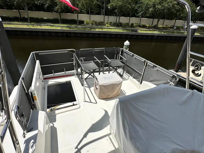 Slide: The Image of Beneteau Swift Trawler 35 deck, 2022 model, featuring seating and covered equipment. - 28