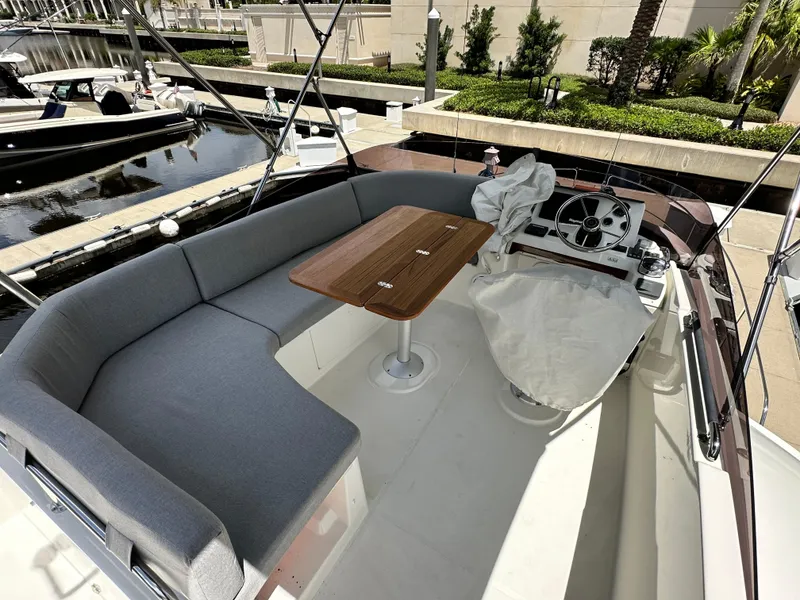 Slide: The Image of 2022 Beneteau Swift Trawler 35 flybridge with seating and helm, docked at marina. - 32