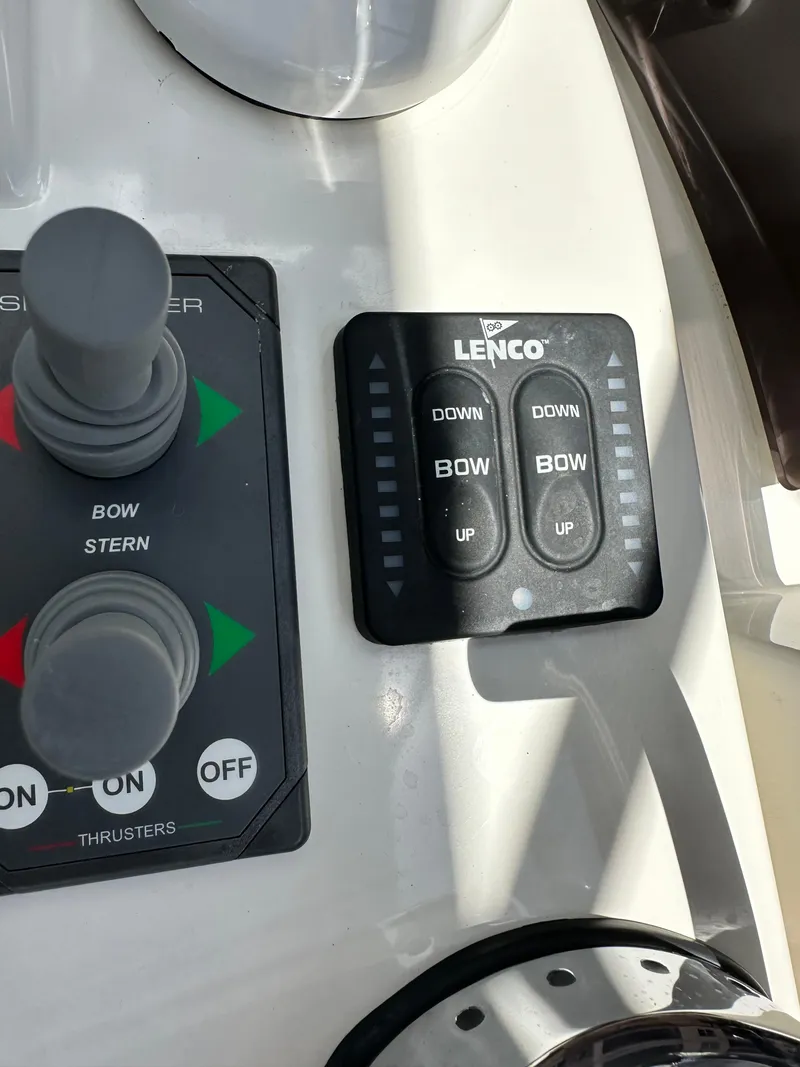 Slide: The Image of Control panel of a 2022 Beneteau Swift Trawler 35 with Lenco trim tab switches. - 35