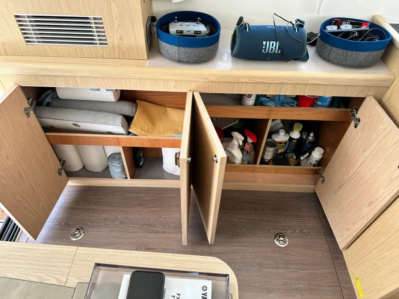 Slide: The Image of Interior storage of 2022 Beneteau Swift Trawler 35 with cleaning supplies and JBL speaker. - 43