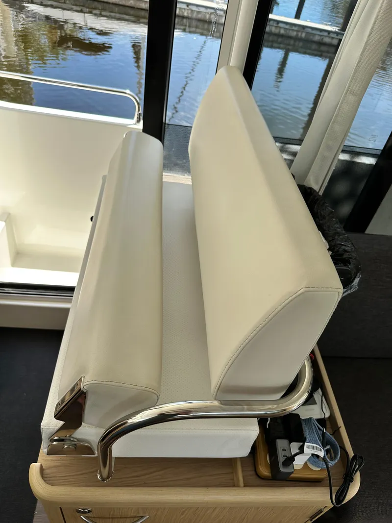 Slide: The Image of Interior seating of 2022 Beneteau Swift Trawler 35, featuring white cushions and metal accents. - 45