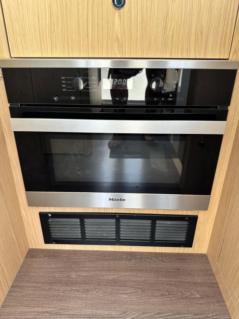 Slide: The Image of Miele oven in 2022 Beneteau Swift Trawler 35, featuring sleek design and modern controls. - 48