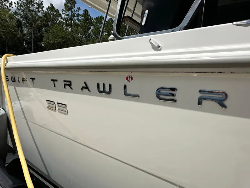 Slide: The Image of 2022 Beneteau Swift Trawler 35 side view with logo and chrome lettering. - 6