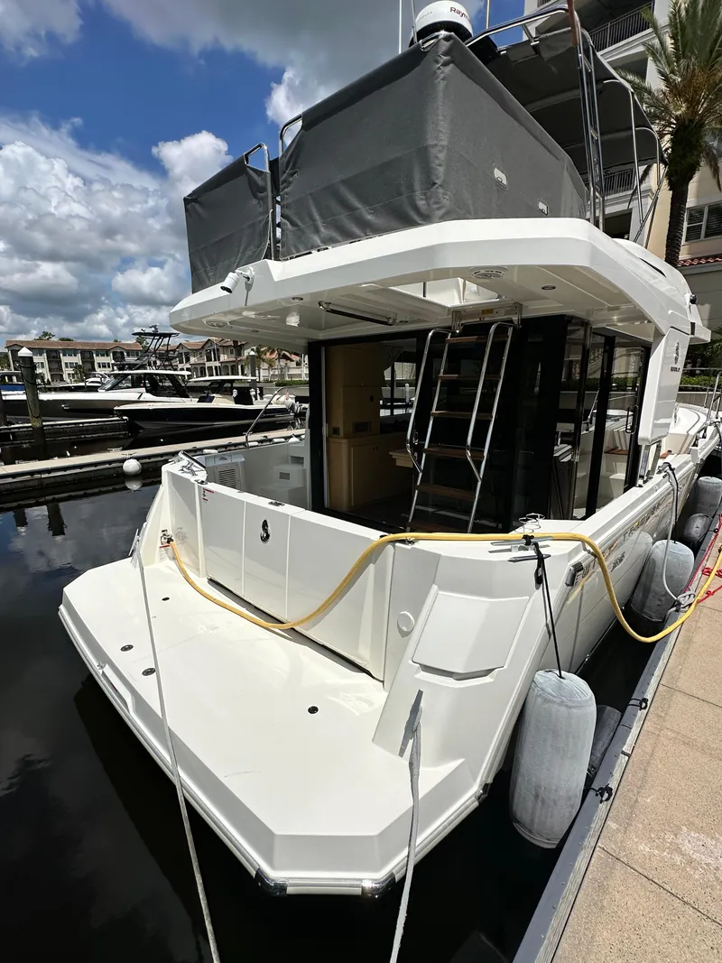 Slide: The Image of 2022 Beneteau Swift Trawler 35 docked at marina, rear view. - 8