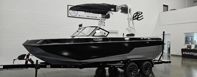 Slide: The Image of 2025 Nautique Super Air Nautique GS20 boat on trailer in showroom. - 1