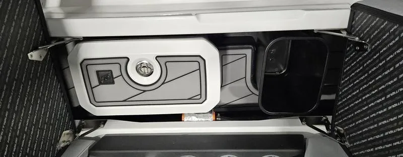 Slide: The Image of 2025 Nautique Super Air Nautique GS20 storage compartment with sleek design and secure latch. - 12