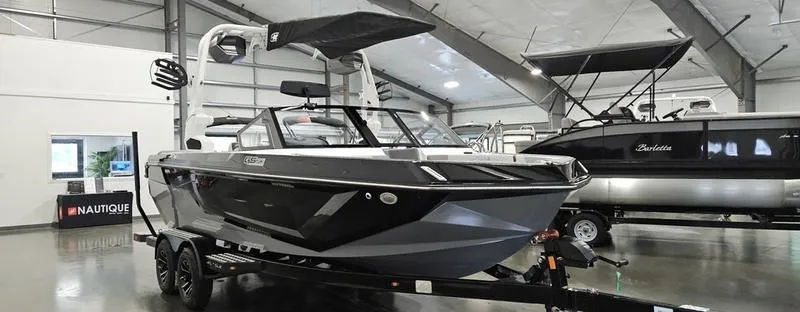 Slide: The Image of 2025 Nautique Super Air Nautique GS20 boat displayed in a showroom. - 4