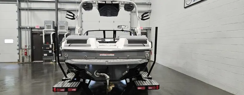 Slide: The Image of 2025 Nautique Super Air Nautique GS20 boat in showroom, rear view. - 5