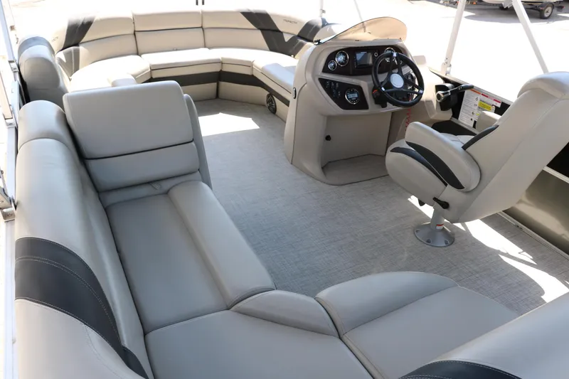Slide: The Image of 2021 Trifecta 24 RFC pontoon boat interior with plush seating and modern helm. - 22