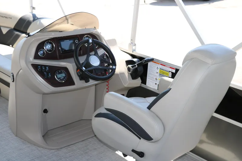 Slide: The Image of 2021 Trifecta 24 RFC boat cockpit with steering wheel and control panel. - 23