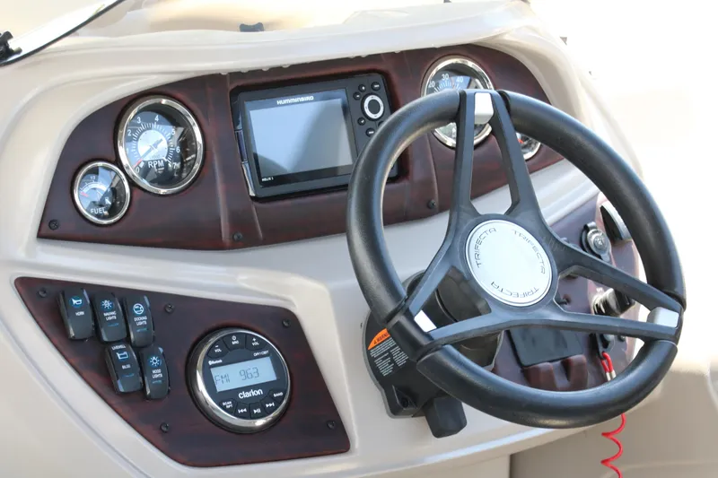 Slide: The Image of Dashboard of 2021 Trifecta 24 RFC boat with steering wheel and gauges. - 24