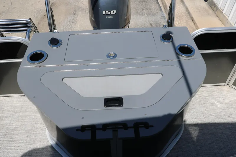 Slide: The Image of 2021 Trifecta 24 RFC boat deck with Yamaha 150 engine, featuring cup holders and storage. - 26