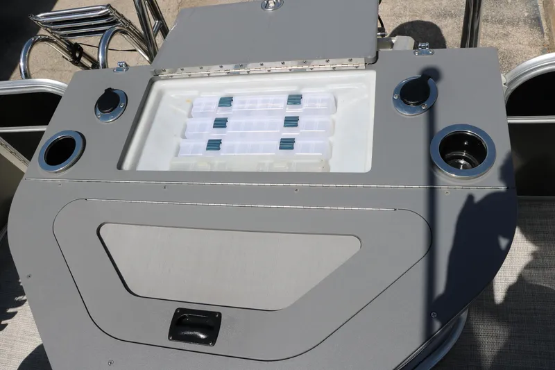 Slide: The Image of 2021 Trifecta 24 RFC boat console with storage compartments and cup holders. - 29