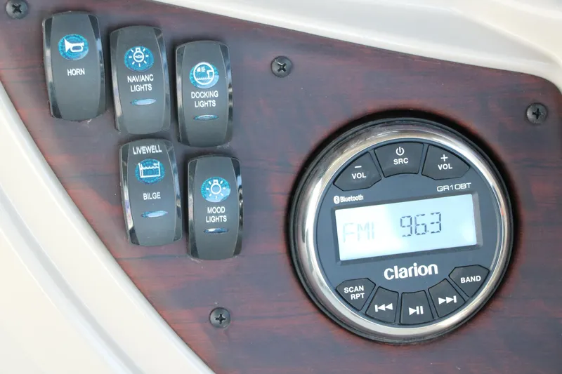 Slide: The Image of Control panel of a 2021 Trifecta 24 RFC boat with switches and Clarion radio. - 32