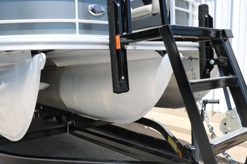 Slide: The Image of 2021 Trifecta 24 RFC pontoon boat on trailer, close-up of pontoons and ladder. - 36