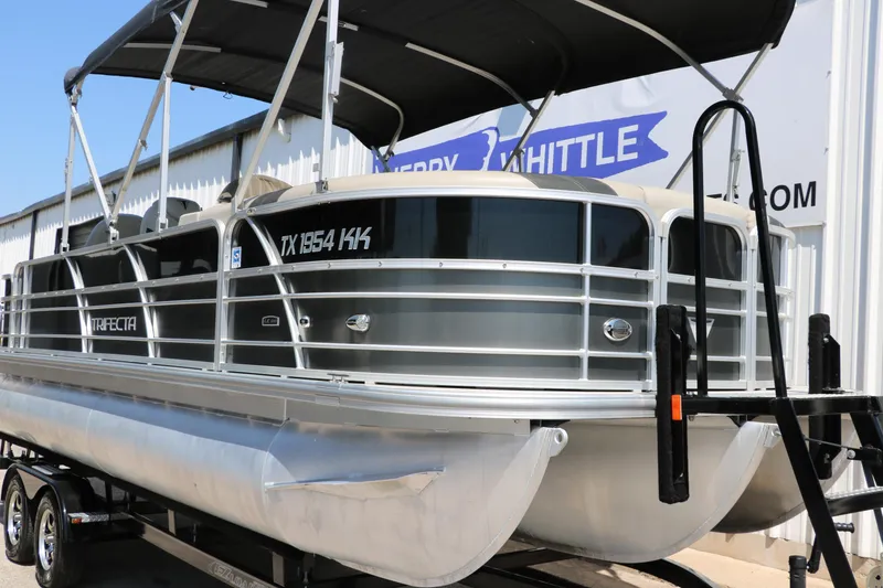 Slide: The Image of 2021 Trifecta 24 RFC pontoon boat on trailer, featuring sleek design and sturdy construction. - 8