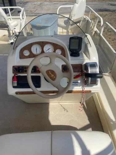 Slide: The Image of 2006 Bentley Pontoons 204 FISH dashboard with steering wheel and gauges. - 6