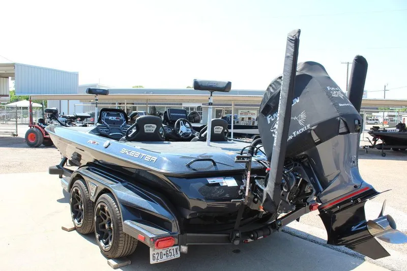 Slide: The Image of 2020 Skeeter FXR21 Apex boat with powerful engine, parked on a trailer. - 15