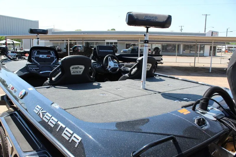 Slide: The Image of 2020 Skeeter FXR21 Apex boat with spacious deck and seating in a showroom. - 16