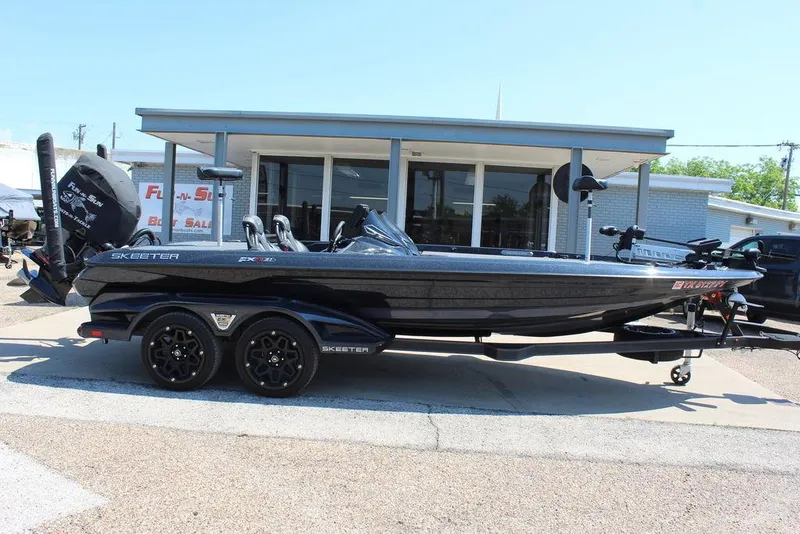Slide: The Image of 2020 Skeeter FXR21 Apex boat on trailer, parked outside a building. - 18