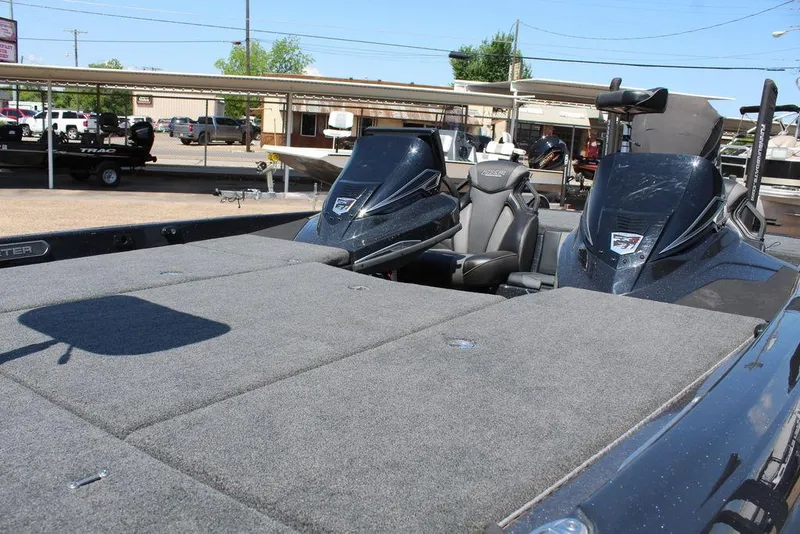 Slide: The Image of 2020 Skeeter FXR21 Apex boat with spacious deck and dual consoles in a marina setting. - 8