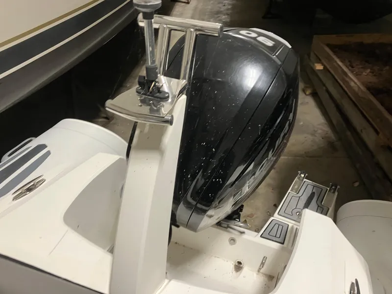 Slide: The Image of 2015 Brig Eagle 480 boat with a 90 HP outboard motor in storage. - 12