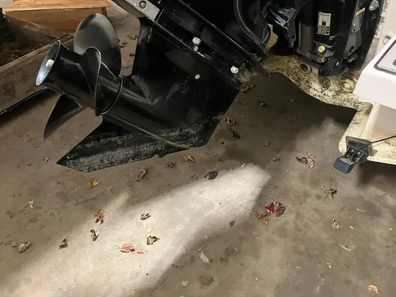 Slide: The Image of 2015 Brig Eagle 480 boat motor and propeller on a concrete floor with scattered leaves. - 15