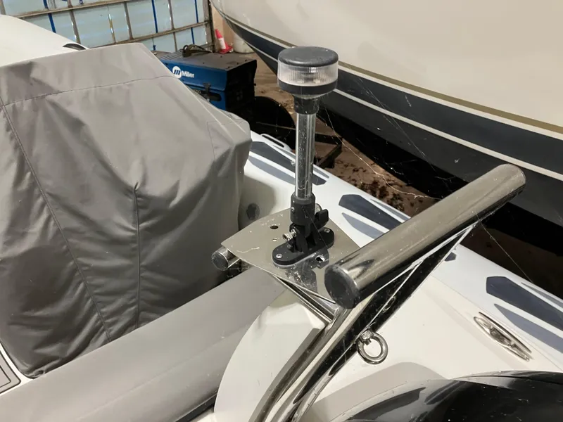 Slide: The Image of 2015 Brig Eagle 480 boat with mounted navigation light and covered seating. - 19