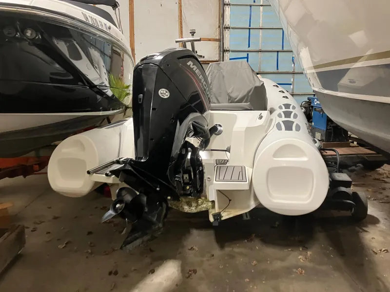 Slide: The Image of 2015 Brig Eagle 480 boat with Mercury outboard motor in storage. - 2