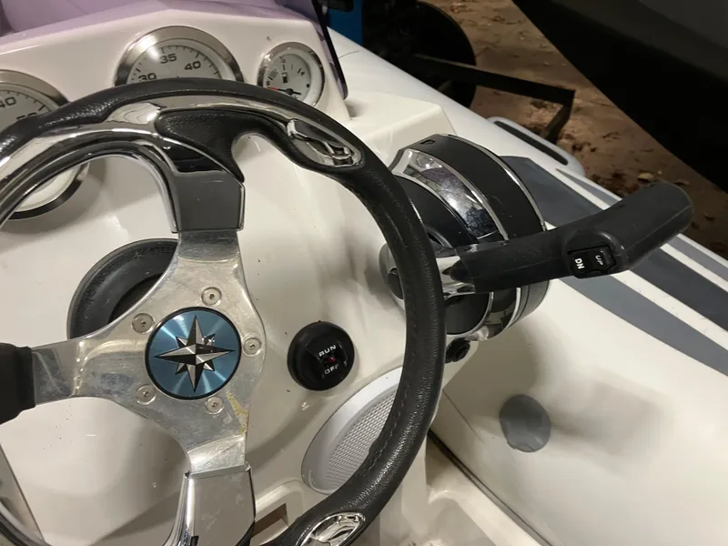 Slide: The Image of Steering wheel and controls of a 2015 Brig Eagle 480 boat. - 9