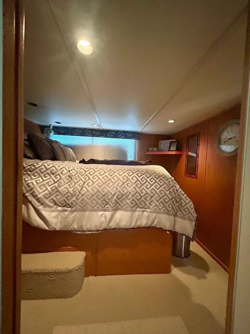 Slide: The Image of Cozy bedroom in a 2002 Sumerset houseboat with patterned bedding and warm lighting. - 17