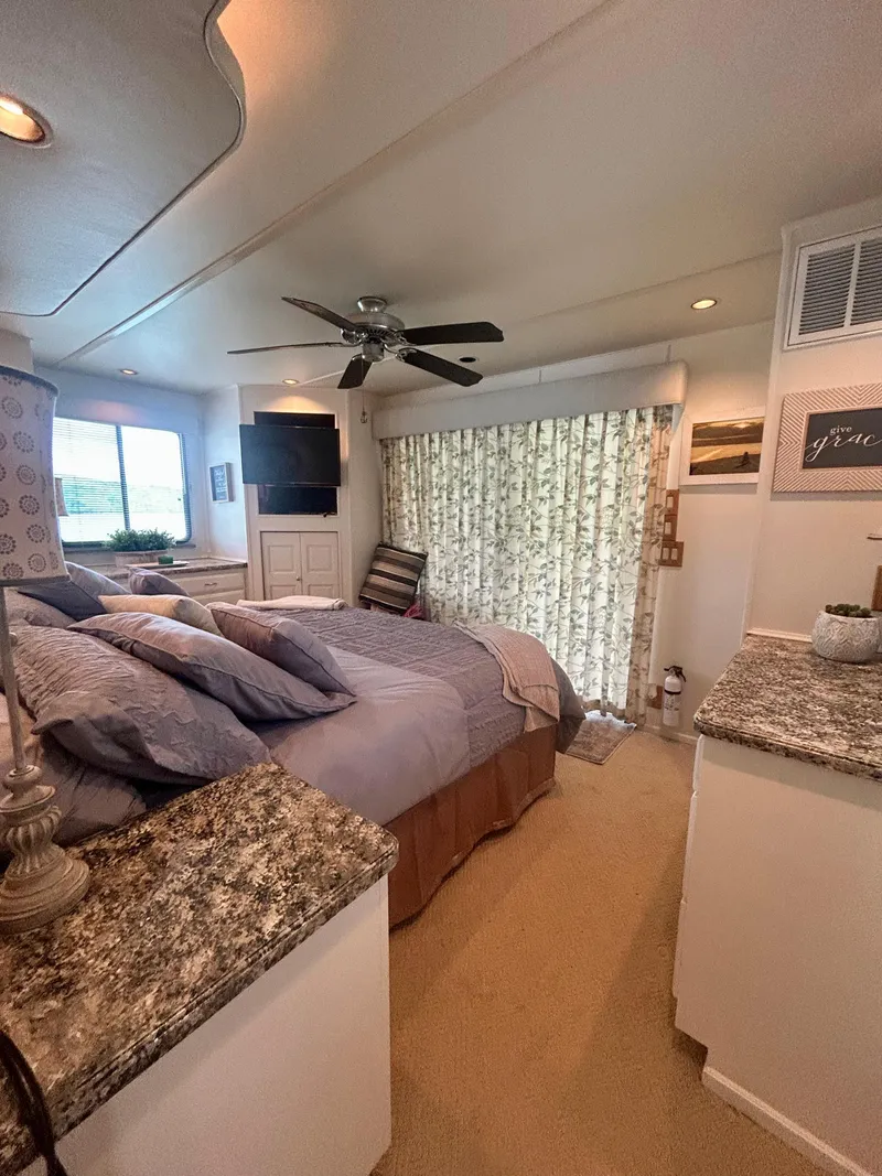 Slide: The Image of Cozy bedroom in a 2002 Sumerset houseboat with modern decor and natural light. - 19