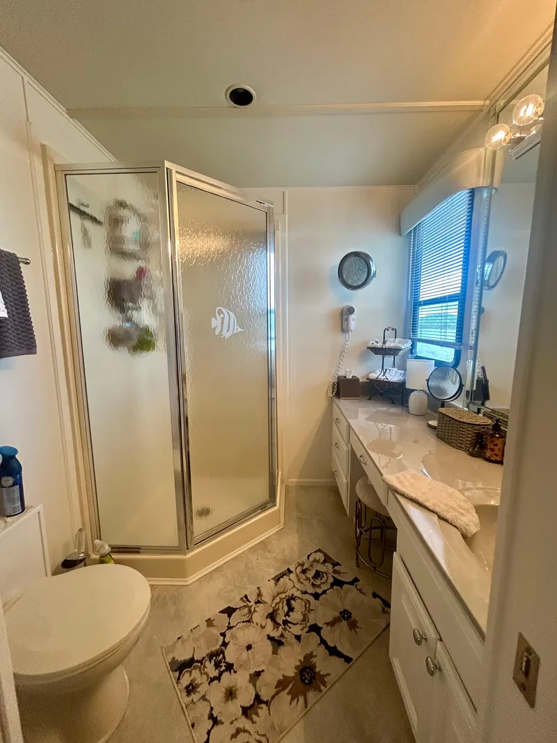 Slide: The Image of Bathroom interior of a 2002 Sumerset houseboat with shower, vanity, and decor. - 21