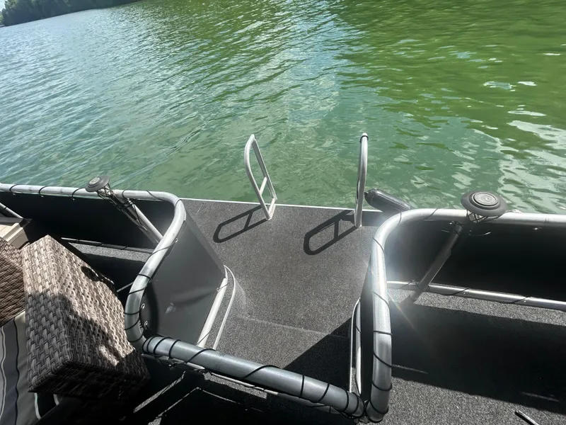 Slide: The Image of 2002 Sumerset houseboat deck with railing, overlooking calm green water. - 23