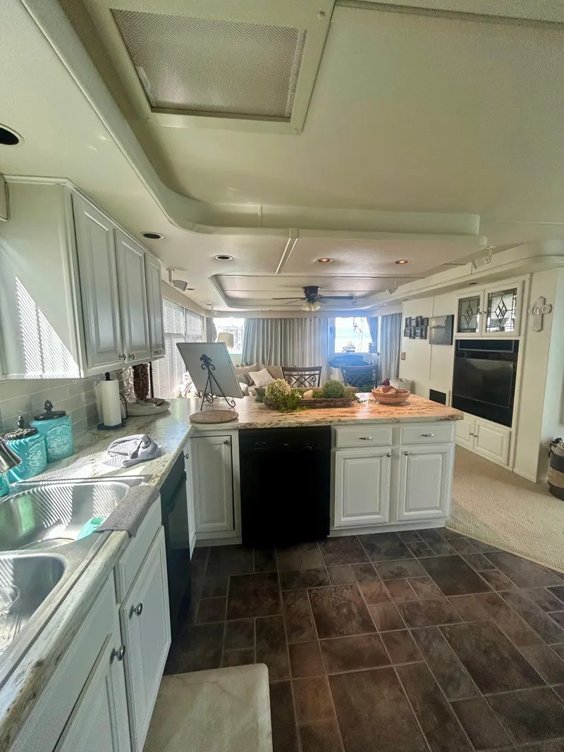Slide: The Image of 2002 Sumerset houseboat kitchen with modern appliances and spacious interior design. - 25
