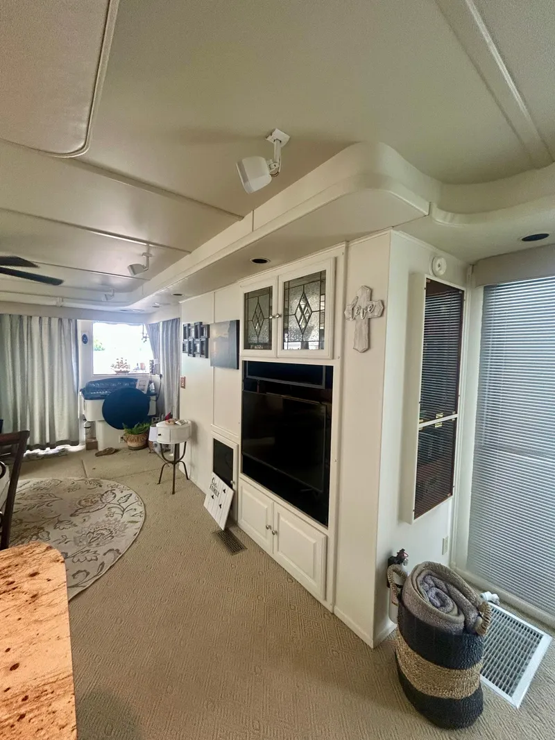 Slide: The Image of Interior of a 2002 Sumerset houseboat featuring a cozy living area with modern decor. - 27