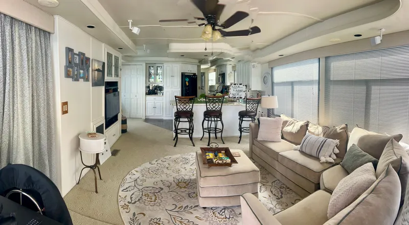 Slide: The Image of Luxurious 2002 Sumerset houseboat interior with cozy living area, modern kitchen, and elegant decor. - 7