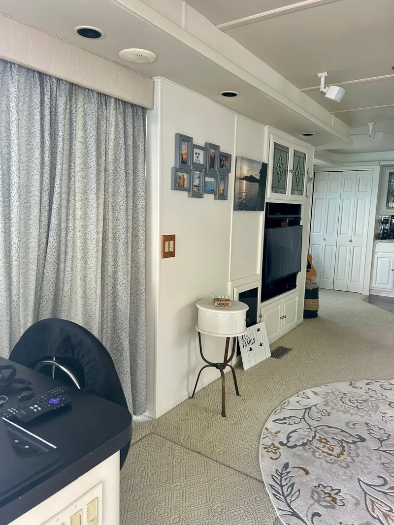 Slide: The Image of Interior of a 2002 Sumerset houseboat with modern decor and entertainment setup. - 8