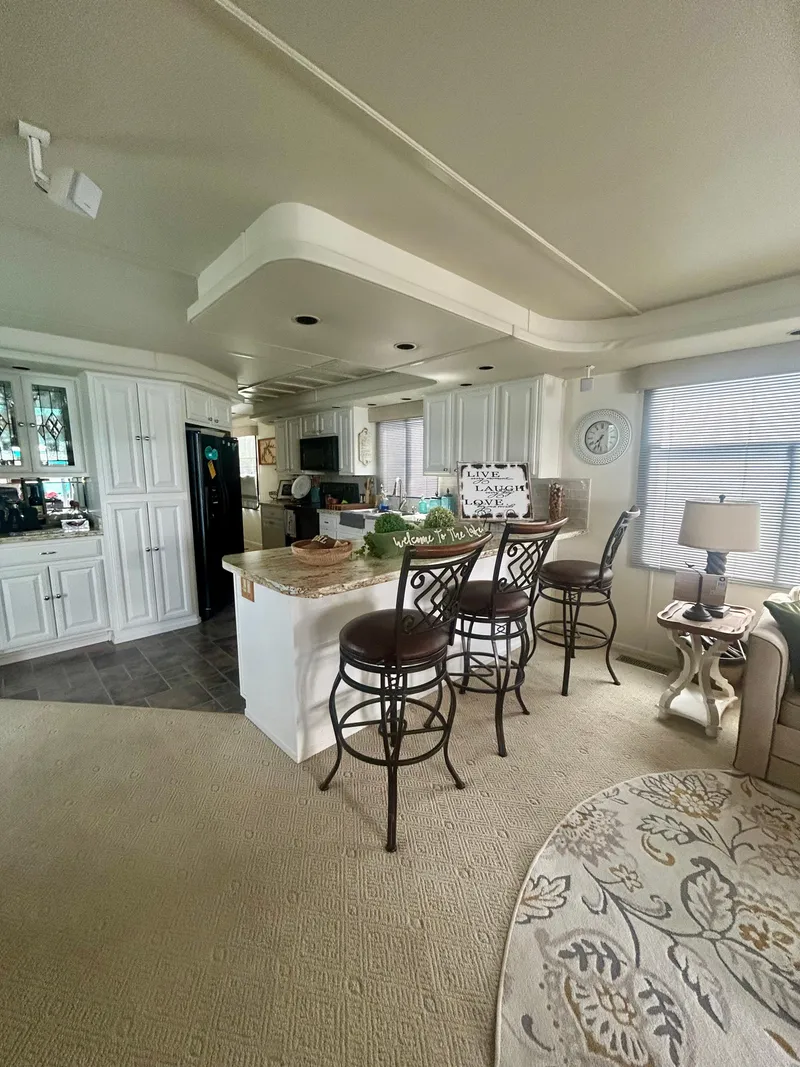 Slide: The Image of Interior of a 2002 Sumerset houseboat with modern kitchen and cozy seating area. - 9