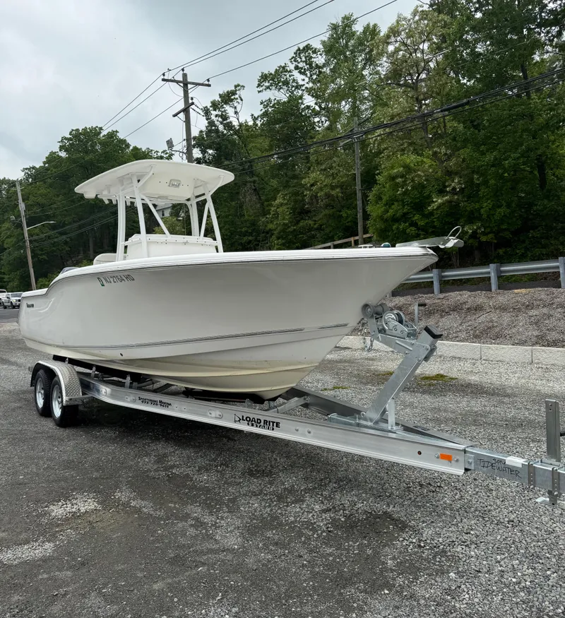 Slide: The Image of 2011 Tidewater 250CC Adventure Twin Engine boat on trailer, parked outdoors. - 13