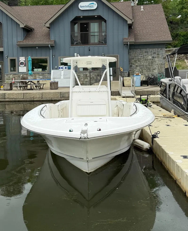 Slide: The Image of 2011 Tidewater 250CC Adventure Twin Engine boat docked at a marina. - 3