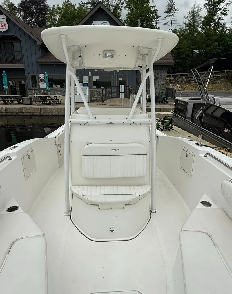 Slide: The Image of 2011 Tidewater 250CC Adventure Twin Engine boat docked at marina. - 5