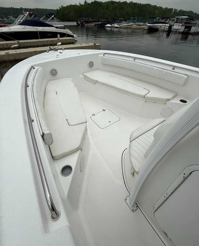 Slide: The Image of 2011 Tidewater 250CC Adventure boat with spacious seating, docked at a marina. - 7