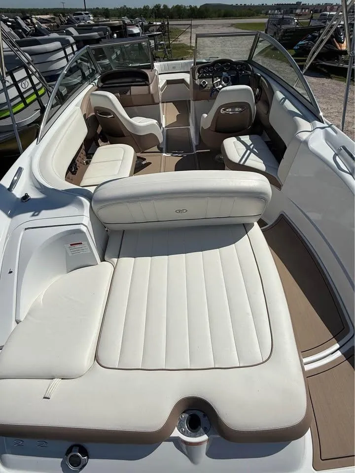 Slide: The Image of 2012 Cobalt 242 boat interior with white seating and sleek design. - 11