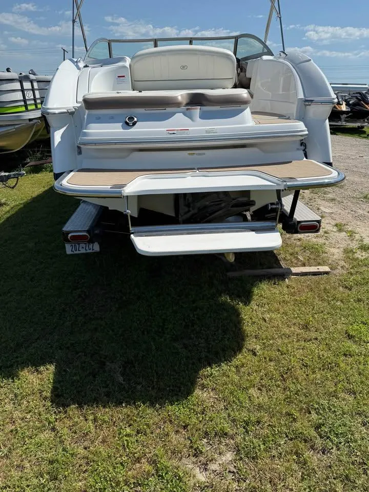 Slide: The Image of 2012 Cobalt 242 boat rear view with swim platform on grass. - 2